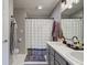 Bathroom featuring a double sink vanity, a walk-in shower with stylish curtains, and neutral decor at 7150 Brant Pointe Cir, Indianapolis, IN 46217