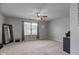 Spacious bedroom with neutral carpet, a ceiling fan, and a large window providing natural light at 7150 Brant Pointe Cir, Indianapolis, IN 46217