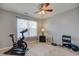 Bedroom with carpet flooring featuring a ceiling fan and fitness equipment; great for staying active at home at 7150 Brant Pointe Cir, Indianapolis, IN 46217