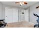 Neutral bedroom with ceiling fan, double closet, and an adjoining doorway at 7150 Brant Pointe Cir, Indianapolis, IN 46217