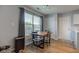 Cozy dining area with a wooden table, four chairs, and a window with natural light illuminating the space at 7150 Brant Pointe Cir, Indianapolis, IN 46217