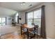 Open-concept dining area with a wooden table, chairs, and a view of the adjacent living space at 7150 Brant Pointe Cir, Indianapolis, IN 46217