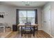 Bright dining area featuring a wooden table, seating for four, and a view of the outdoors at 7150 Brant Pointe Cir, Indianapolis, IN 46217