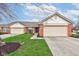 Home exterior with a two-car garage, brick accents, and a beautifully maintained lawn at 7150 Brant Pointe Cir, Indianapolis, IN 46217