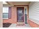Close-up of front door with 'Welcome' mat, and brick detailing surrounding the entrance at 7150 Brant Pointe Cir, Indianapolis, IN 46217