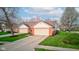 Attractive brick and siding home featuring a two-car garage, a well-kept lawn, and mature trees at 7150 Brant Pointe Cir, Indianapolis, IN 46217