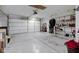 Spacious garage featuring a large door, epoxy flooring and wall shelving at 7150 Brant Pointe Cir, Indianapolis, IN 46217