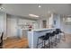 An open-concept kitchen with white cabinets, a breakfast bar, and modern appliances at 7150 Brant Pointe Cir, Indianapolis, IN 46217