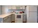 Well-lit kitchen featuring white appliances, gray cabinets, and plenty of counter space for cooking and prepping at 7150 Brant Pointe Cir, Indianapolis, IN 46217