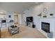 Bright living room featuring a fireplace, modern decor, and neutral carpet at 7150 Brant Pointe Cir, Indianapolis, IN 46217