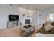 Comfortable living room with a fireplace, neutral carpet, and stylish furniture at 7150 Brant Pointe Cir, Indianapolis, IN 46217