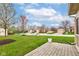 View of the street showing a row of houses, green lawns, and landscaping at 7150 Brant Pointe Cir, Indianapolis, IN 46217