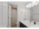 Bathroom with a white vanity and a view into the shower, showcasing modern fixtures at 7322 Franklin Parke Ct, Indianapolis, IN 46259