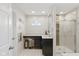 Bright bathroom featuring a vanity, makeup area, walk-in shower with glass doors, and modern finishes at 7322 Franklin Parke Ct, Indianapolis, IN 46259