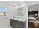 Bathroom featuring a vanity with a white countertop and large mirror, with a view into the bedroom at 7322 Franklin Parke Ct, Indianapolis, IN 46259