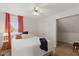 Cozy bedroom with a comfortable bed, side table, and window with orange curtains at 7322 Franklin Parke Ct, Indianapolis, IN 46259