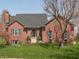 Charming brick home features a well-manicured lawn and inviting front entrance, creating a warm and welcoming curb appeal at 7322 Franklin Parke Ct, Indianapolis, IN 46259