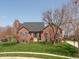 Charming brick home features a well-manicured lawn and mature trees, creating a welcoming curb appeal at 7322 Franklin Parke Ct, Indianapolis, IN 46259