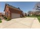 Side view of a two-car garage with an expansive concrete driveway and basketball hoop at 7322 Franklin Parke Ct, Indianapolis, IN 46259