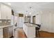 Bright kitchen features an island, stainless steel appliances, granite countertops, and hardwood floors at 7322 Franklin Parke Ct, Indianapolis, IN 46259