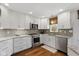 Well-lit kitchen with stainless steel appliances, granite countertops, and wood flooring at 7322 Franklin Parke Ct, Indianapolis, IN 46259