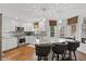 Open kitchen with island seating, stainless appliances, granite counters, and stylish pendant lighting at 7322 Franklin Parke Ct, Indianapolis, IN 46259
