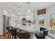 Kitchen island with seating, stainless appliances, granite counters, and walkout access to the yard at 7322 Franklin Parke Ct, Indianapolis, IN 46259