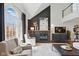Spacious living room with a fireplace, large window, high ceilings, and comfortable seating area at 7322 Franklin Parke Ct, Indianapolis, IN 46259