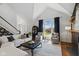 Bright living room featuring a vaulted ceiling, fireplace, and hardwood floors at 7322 Franklin Parke Ct, Indianapolis, IN 46259