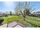 Enjoy outdoor relaxation on this wooden deck with an expansive backyard view featuring lush greenery and mature trees at 745 W Banta Rd, Indianapolis, IN 46217