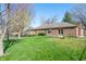 The house has a brick facade and a cozy backyard with a wood deck and a well-maintained green lawn at 745 W Banta Rd, Indianapolis, IN 46217