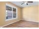 Bright bedroom featuring hardwood floors, a ceiling fan, and a large window at 745 W Banta Rd, Indianapolis, IN 46217