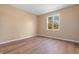 Empty bedroom with hardwood floors, neutral walls, and bright window at 745 W Banta Rd, Indianapolis, IN 46217