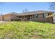 Brick home boasts a well-maintained lawn with green shutters and mature landscaping at 745 W Banta Rd, Indianapolis, IN 46217