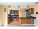 Updated kitchen with stainless steel appliances, dark countertops, and mosaic tile backsplash at 745 W Banta Rd, Indianapolis, IN 46217