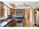 Kitchen features stainless steel appliances, mosaic tile backsplash, and hardwood floors at 745 W Banta Rd, Indianapolis, IN 46217