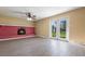 Spacious living room featuring a brick fireplace and glass doors to the outside at 745 W Banta Rd, Indianapolis, IN 46217