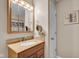 Bathroom with a light wood vanity, granite countertop and a mirror with vanity lights at 758 Stafford Rd, Plainfield, IN 46168