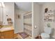 Bathroom featuring a combination shower and tub, a wood vanity with gold hardware, and a shelf at 758 Stafford Rd, Plainfield, IN 46168