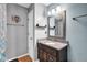 Bathroom with a light blue wall, dark vanity and framed mirror at 758 Stafford Rd, Plainfield, IN 46168