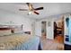Bedroom with a ceiling fan, wood-look floors and access to the bathroom and closet at 758 Stafford Rd, Plainfield, IN 46168