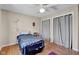 Well-lit bedroom with ceiling fan, hardwood floors, a double bed, and two large closets with curtains at 758 Stafford Rd, Plainfield, IN 46168