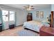 Bedroom with light blue walls, wood-look flooring, a ceiling fan and a window at 758 Stafford Rd, Plainfield, IN 46168