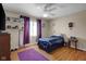 Bright bedroom featuring hardwood floors, a ceiling fan, a bed, and a dresser, with natural light from a window at 758 Stafford Rd, Plainfield, IN 46168