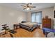 Bedroom with wood floor, blue patterned curtains, a ceiling fan, and a simple bed at 758 Stafford Rd, Plainfield, IN 46168