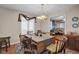 Bright dining room features a large wooden table with seating for eight and an open view to the kitchen at 758 Stafford Rd, Plainfield, IN 46168