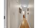 Hallway offers a view of hardwood floors, neutral walls with artwork, doors, and access to other rooms at 758 Stafford Rd, Plainfield, IN 46168