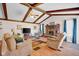 Inviting living room with exposed beams, cozy seating, brick fireplace, and colorful accents create a warm ambiance at 758 Stafford Rd, Plainfield, IN 46168
