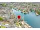 Aerial view of lakefront homes surrounded by lush trees, with a home location pin visible at 7591 Inkbush Dr, Nineveh, IN 46164