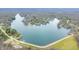 Expansive aerial view of lakefront properties showcasing beautiful lake houses surrounded by lush trees and serene water at 7591 Inkbush Dr, Nineveh, IN 46164